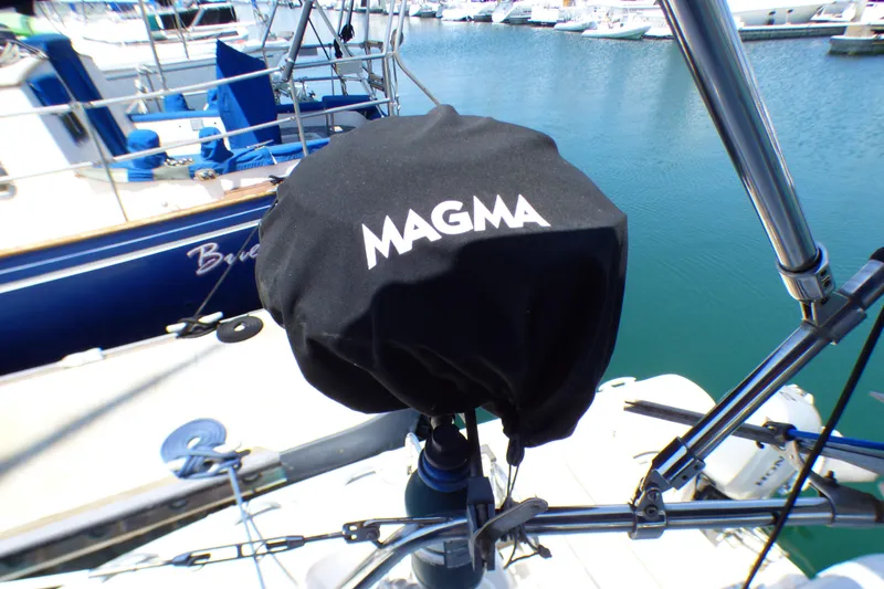 Slide: The Image of Black Magma grill cover on a 1993 Hunter 40.5 sailboat at a marina. - 58