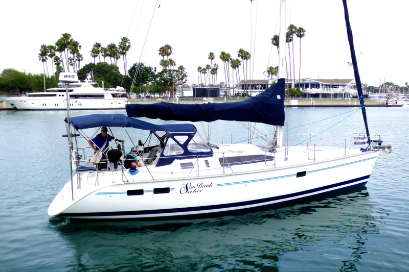 Slide: The Image of Sailboat Hunter 40.5 (1993) docked in marina with palm trees in background. - 6