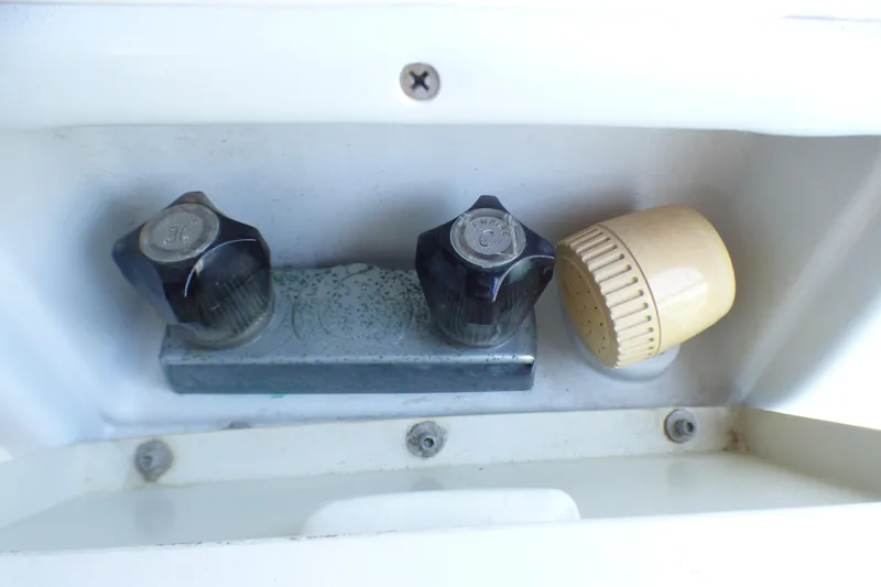 Slide: The Image of Close-up of Hunter 40.5 1993 boat shower controls with knobs and spray nozzle. - 62