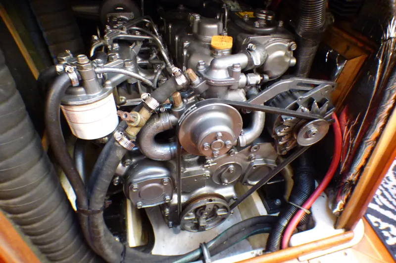 Slide: The Image of Engine of a 1993 Hunter 40.5 sailboat, showcasing mechanical components and hoses. - 63