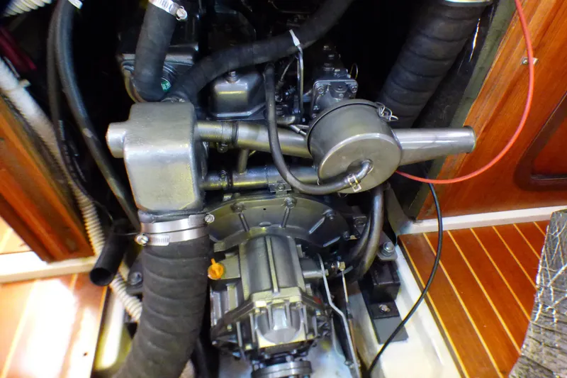Slide: The Image of Engine compartment of a 1993 Hunter 40.5 sailboat, showcasing mechanical components and hoses. - 64