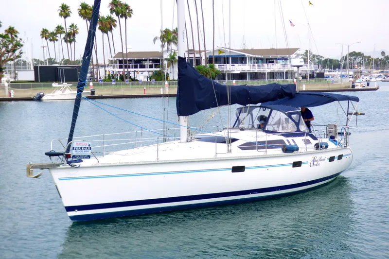Slide: The Image of Sailboat Hunter 40.5, 1993 model, docked with "For Sale" sign, marina background. - 7