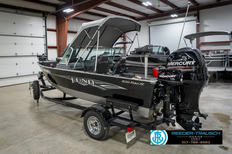 Slide: The Image of 2014 Lund 1650 Rebel XS boat with Mercury engine in a showroom. - 10