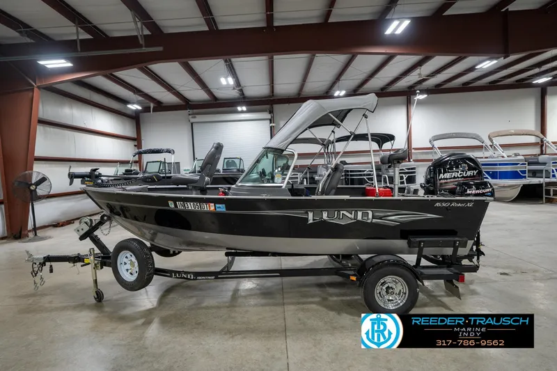 Slide: The Image of 2014 Lund 1650 Rebel XS boat on trailer in indoor showroom. - 11