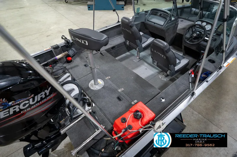 Slide: The Image of 2014 Lund 1650 Rebel XS boat interior with Mercury engine and seating arrangement. - 14