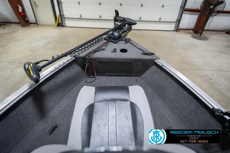 Slide: The Image of 2014 Lund 1650 Rebel XS boat interior with trolling motor in garage. - 18