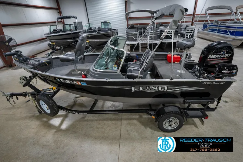 Slide: The Image of 2014 Lund 1650 Rebel XS fishing boat with Mercury engine in showroom. - 2