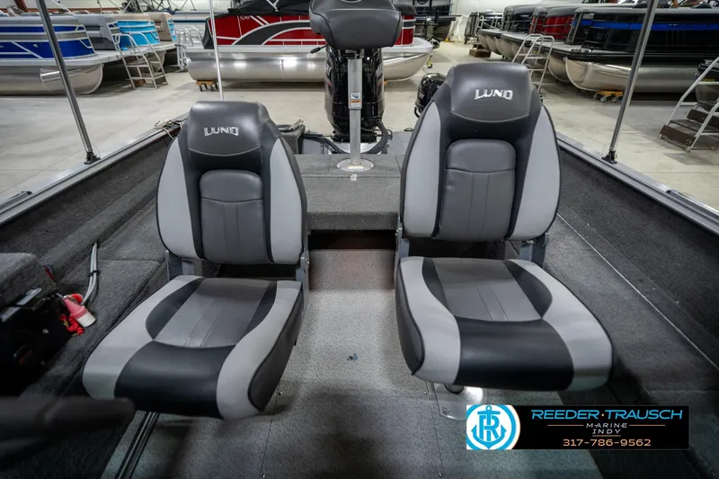 Slide: The Image of 2014 Lund 1650 Rebel XS boat interior with two gray and black seats. - 20
