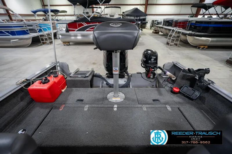 Slide: The Image of 2014 Lund 1650 Rebel XS boat interior with motor and equipment in showroom. - 21