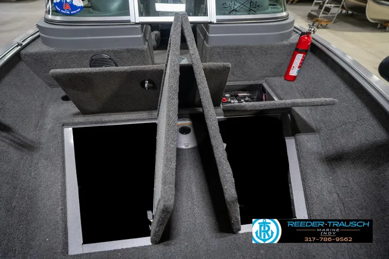 Slide: The Image of 2014 Lund 1650 Rebel XS boat interior with open storage compartments and fire extinguisher. - 23
