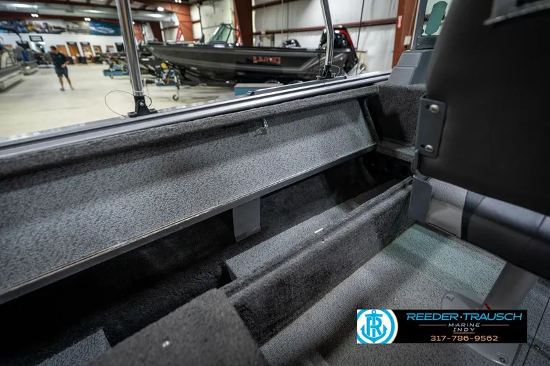 Slide: The Image of Interior view of a 2014 Lund 1650 Rebel XS boat in a showroom. - 25