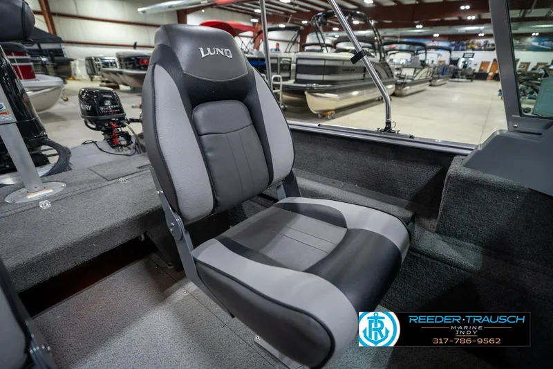 Slide: The Image of 2014 Lund 1650 Rebel XS boat seat in showroom, featuring comfortable design and modern upholstery. - 26