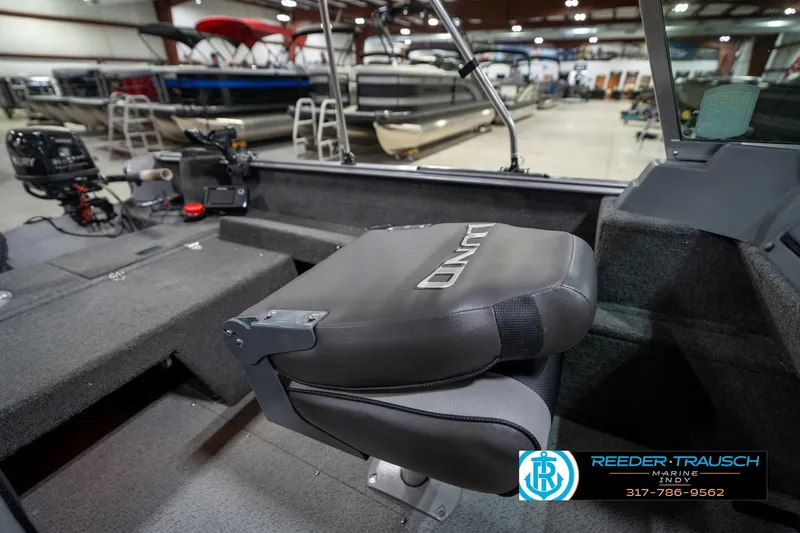 Slide: The Image of 2014 Lund 1650 Rebel XS boat interior with seating and equipment in showroom. - 27
