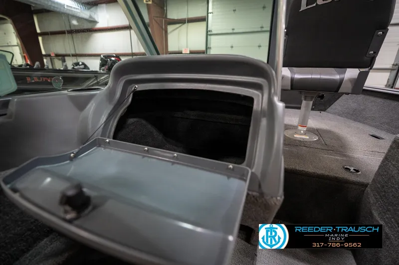 Slide: The Image of 2014 Lund 1650 Rebel XS boat interior with open storage compartment. - 29