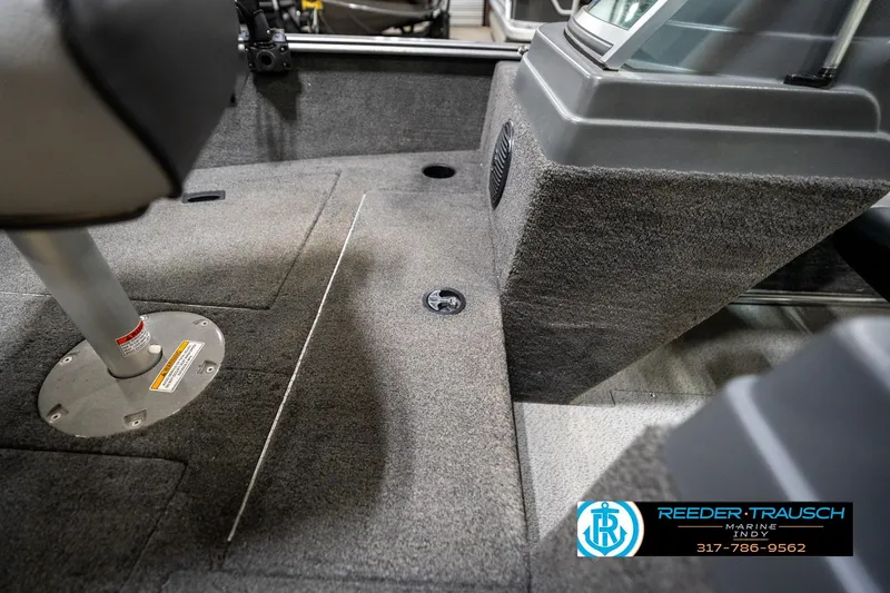 Slide: The Image of Interior of 2014 Lund 1650 Rebel XS boat, featuring carpeted flooring and seating. - 30
