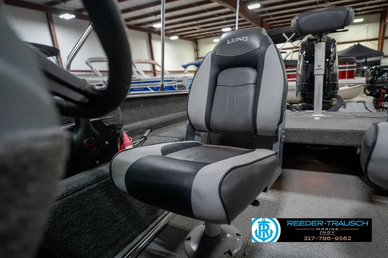 Slide: The Image of 2014 Lund 1650 Rebel XS boat interior with seating and steering wheel. - 32