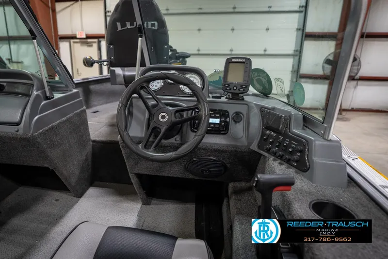 Slide: The Image of 2014 Lund 1650 Rebel XS boat interior with steering wheel and control panel. - 33