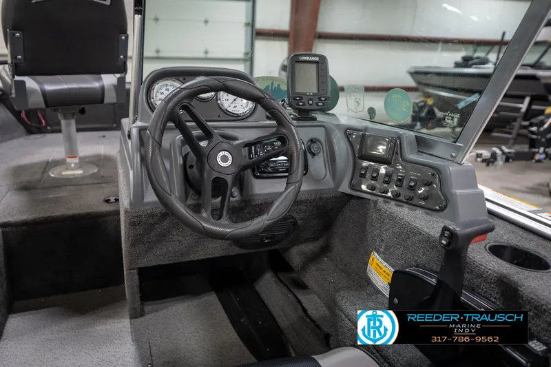 Slide: The Image of 2014 Lund 1650 Rebel XS boat cockpit with steering wheel and control panel. - 34