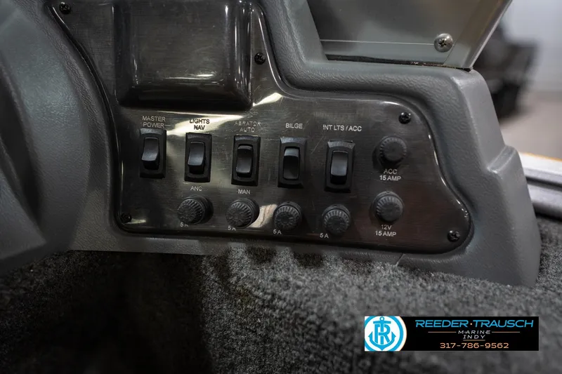 Slide: The Image of Control panel of a 2014 Lund 1650 Rebel XS boat with various switches and dials. - 41