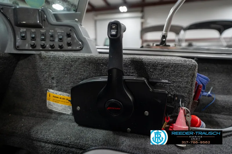 Slide: The Image of 2014 Lund 1650 Rebel XS boat control panel with throttle lever and switches. - 42
