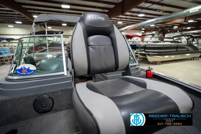 Slide: The Image of 2014 Lund 1650 Rebel XS boat interior with seating and windshield in showroom. - 43