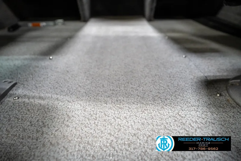 Slide: The Image of 2014 Lund 1650 Rebel XS boat interior flooring, textured surface, Reeder Trausch Marine logo. - 47