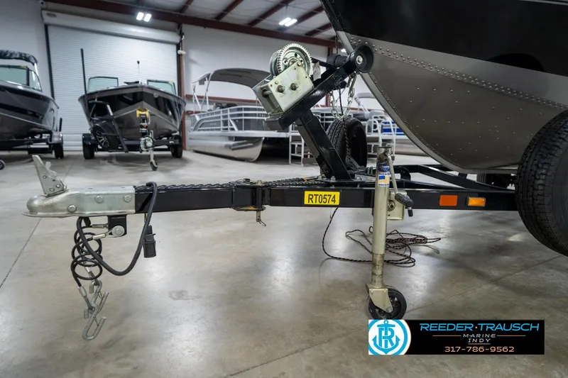 Slide: The Image of 2014 Lund 1650 Rebel XS boat trailer in showroom with other boats. - 48