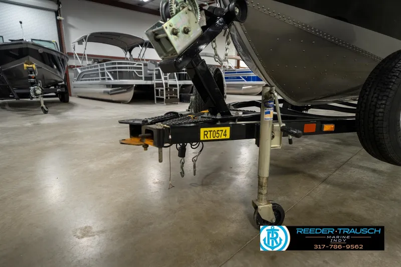 Slide: The Image of 2014 Lund 1650 Rebel XS boat trailer in indoor showroom. - 49