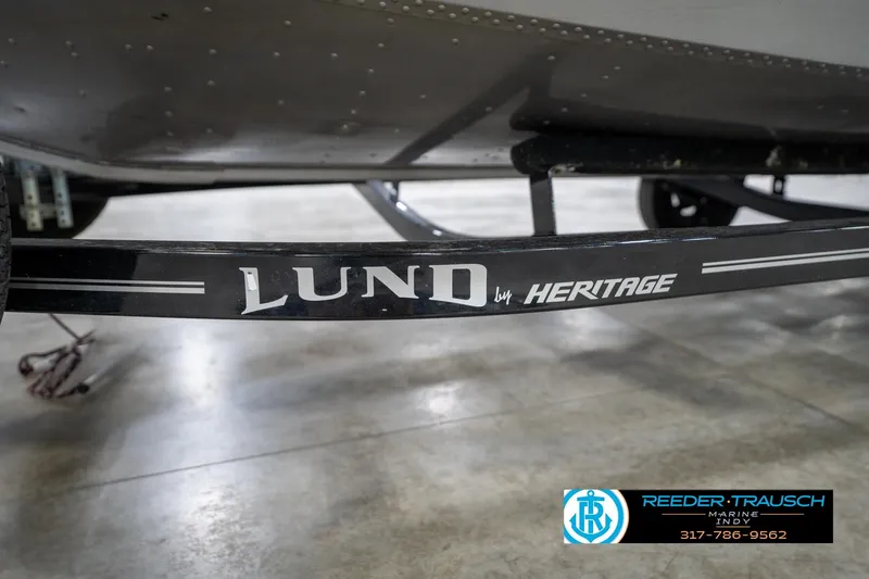 Slide: The Image of 2014 Lund 1650 Rebel XS boat trailer by Heritage, displayed indoors. - 50
