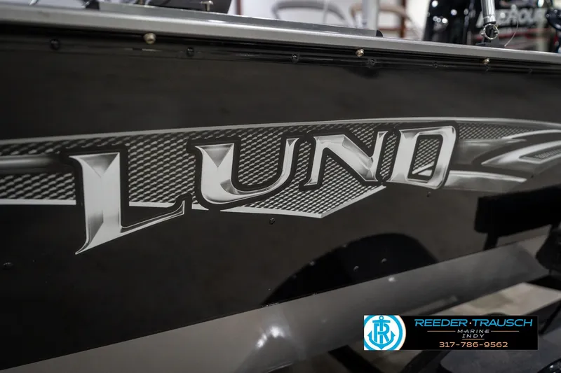 Slide: The Image of 2014 Lund 1650 Rebel XS boat with bold logo and Reeder Trausch Marine branding. - 51