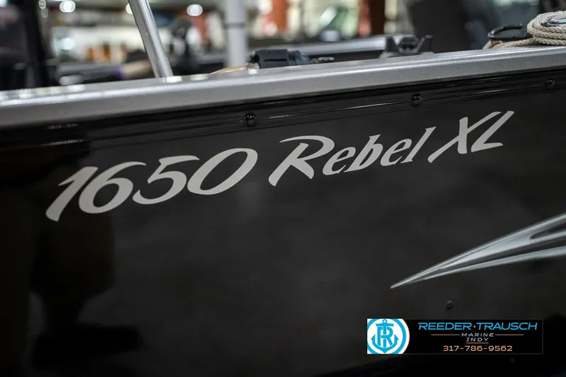 Slide: The Image of 2014 Lund 1650 Rebel XS boat with branding and contact information. - 52