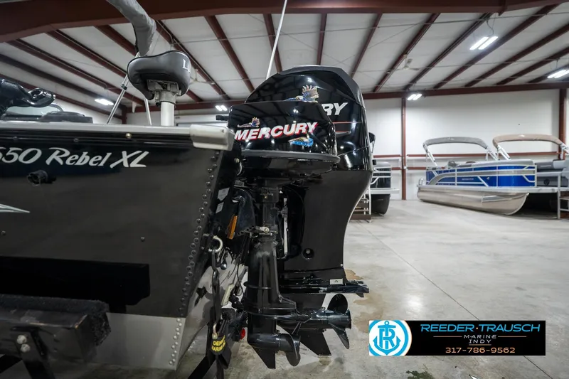 Slide: The Image of 2014 Lund 1650 Rebel XS boat with Mercury engine in indoor showroom. - 57