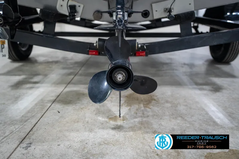 Slide: The Image of 2014 Lund 1650 Rebel XS boat propeller and trailer in a showroom. - 63