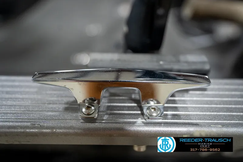 Slide: The Image of Chrome boat cleat on a 2014 Lund 1650 Rebel XS, Reeder-Trausch Marine logo visible. - 64