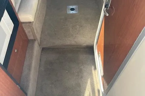 Slide: The Image of Interior view of a 2001 Chaparral 265 SSi boat with carpeted flooring. - 12