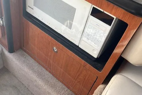 Slide: The Image of Microwave in 2001 Chaparral 265 SSi boat interior, wooden cabinetry. - 13