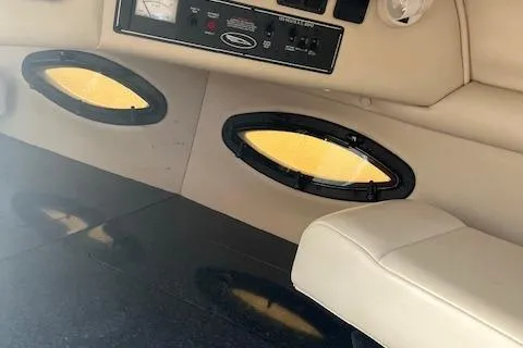 Slide: The Image of Interior of a 2001 Chaparral 265 SSi boat with beige seating and oval windows. - 14