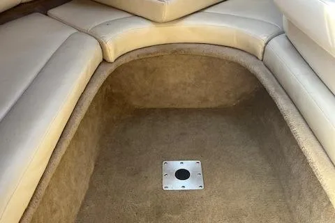 Slide: The Image of 2001 Chaparral 265 SSi boat interior with beige seating and carpeted flooring. - 17
