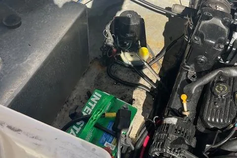 Slide: The Image of Engine compartment of a 2001 Chaparral 265 SSi boat with visible battery and components. - 20