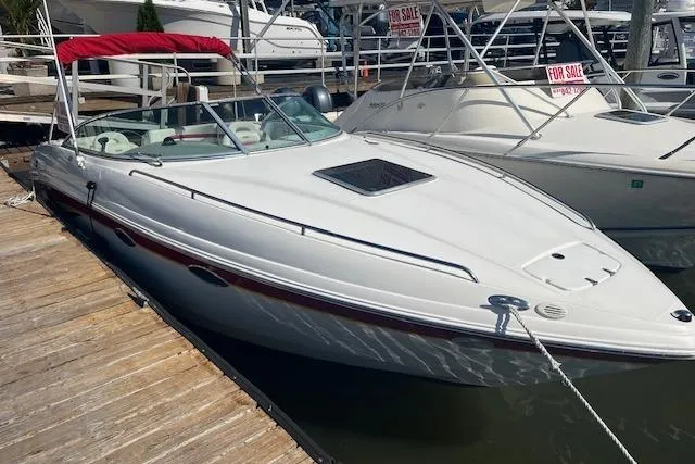 Slide: The Image of 2001 Chaparral 265 SSi boat docked, white exterior, red canopy, for sale sign visible. - 4