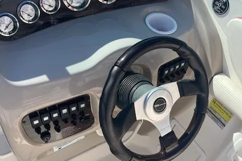 Slide: The Image of Steering wheel and dashboard of 2001 Chaparral 265 SSi boat with gauges and controls. - 6