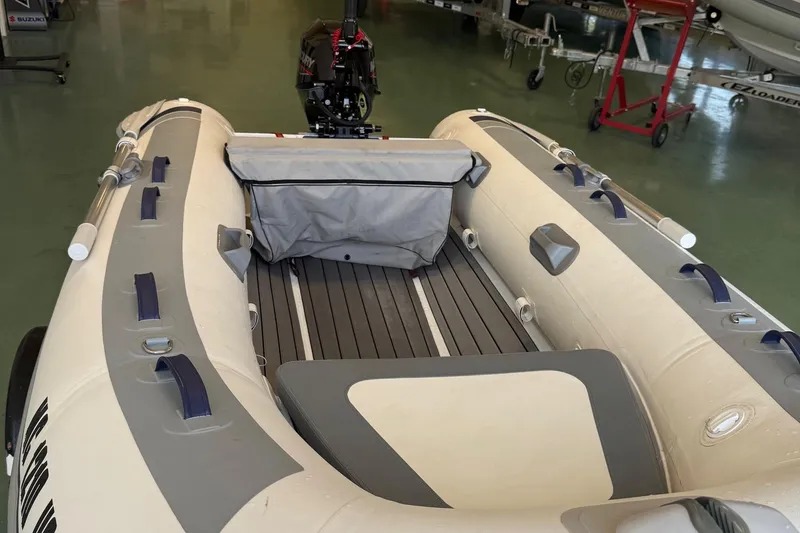 Slide: The Image of 2022 Highfield Classic 310 inflatable boat with motor, in a showroom setting. - 3