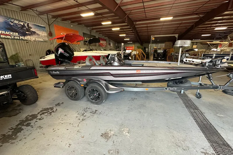 Slide: The Image of 2021 Bass Cat Pantera II boat in showroom, on trailer, with visible equipment. - 13