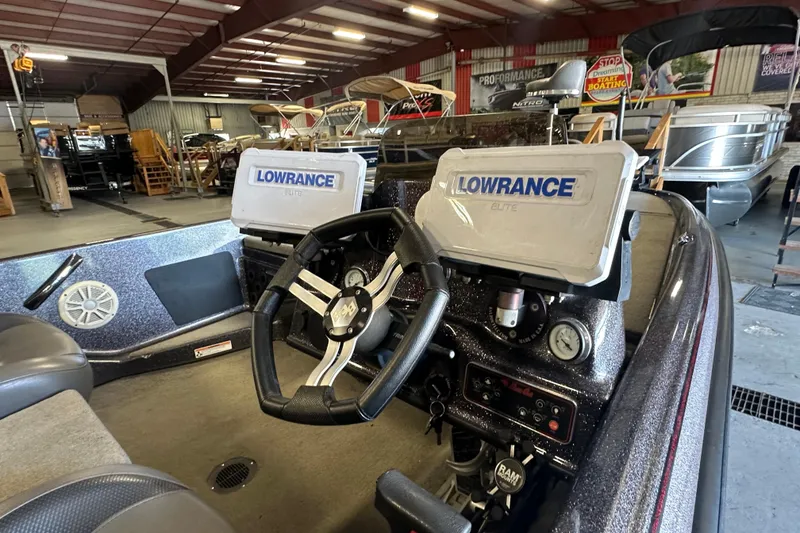 Slide: The Image of 2021 Bass Cat Pantera II boat interior with Lowrance Elite displays in a showroom. - 19