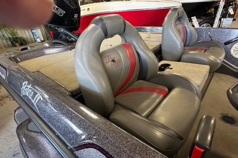 Slide: The Image of 2021 Bass Cat Pantera II boat interior with gray and red seats. - 20