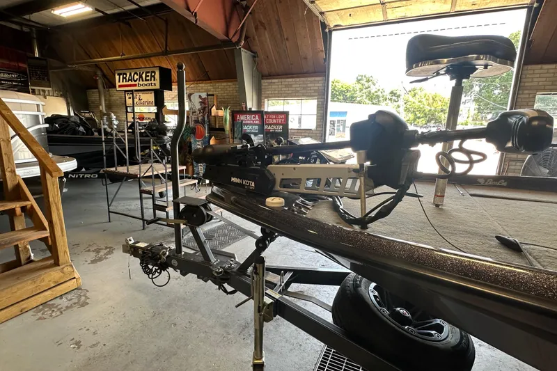 Slide: The Image of 2021 Bass Cat Pantera II boat in a garage with Minn Kota trolling motor. - 26