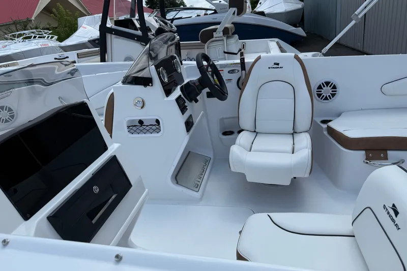 Slide: The Image of 2025 Stingray 172DC boat interior with white seating and modern dashboard. - 3