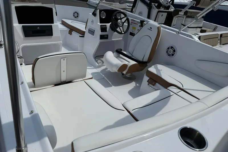 Slide: The Image of 2025 Stingray 172DC boat interior with white seating and modern dashboard. - 5