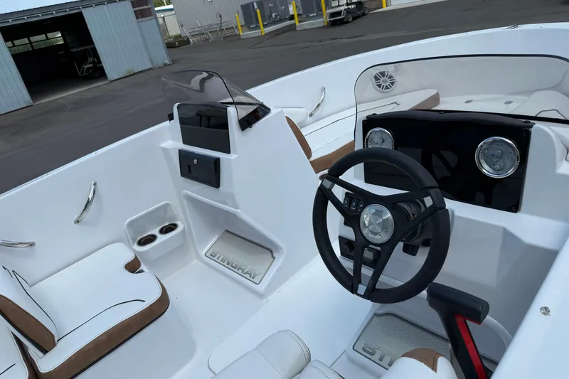 Slide: The Image of 2025 Stingray 172DC boat interior with steering wheel and seating. - 6