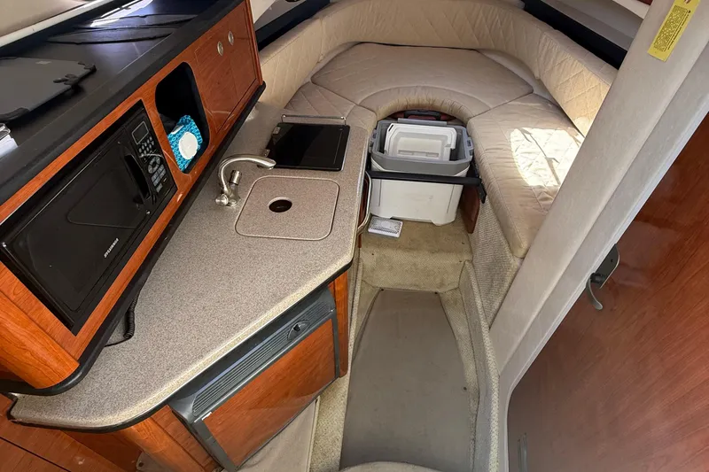 Slide: The Image of 2007 Sea Ray 260 Sundancer cabin interior with kitchenette and seating area. - 11